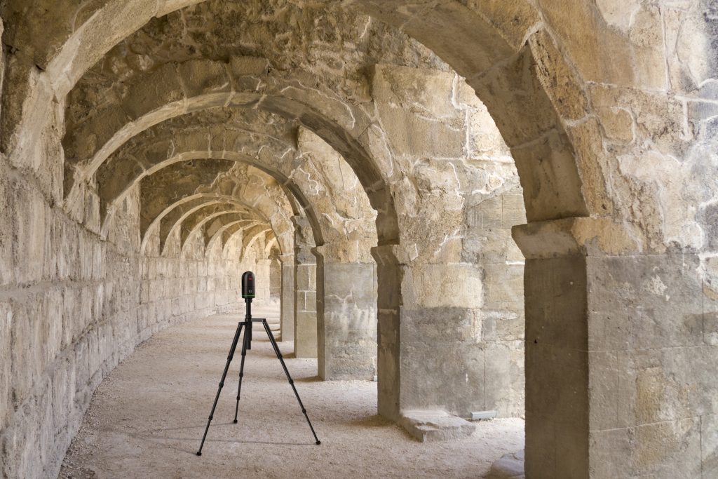 BLK360 laser scanner in front of a stone archway