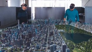 Technologists wearing VR headsets view Smart Digital Reality in their office